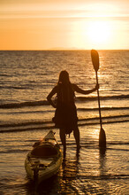 A Woman Watching The Sunset With Her Sea Kayak In Kino Bay, Mexico.