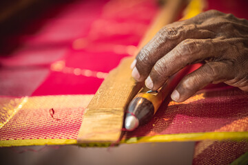 Knchipuram handloom weaver hand crafted closeup shot. The Kanchipuram silk sari is a type of silk sari made in the Kanchipuram region in Tamil Nadu, India.