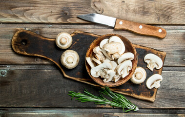 Poster - Pieces of fragrant mushrooms in bowl on cutting Board