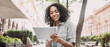 © kite_rin - Young black woman using digital tablet in a city panoramic banner. Smiling student girl texting on tablet outdoor. Modern lifestyle, connection, casual business concept