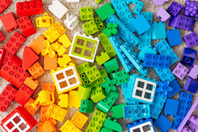 Top View Of Various Colorful Rainbow Colored Constructor Pieces. Bright Stackable Plastic Toy Bricks Sorting By Colors. Educational Games For Colors Sorting. Developing Montessori Toddlers Activities.