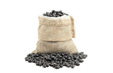 Wall Mural - Black beans in burlap isolated on white background