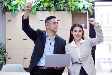 Wall Mural - Employee holding a laptop, smiling, happy. Business concept.