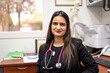 © Austockphoto - portrait of female doctor in her medical office looking at camera smiling