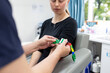 © Austockphoto - Closeup shot of a healthcare worker putting a medical tourniquet on a woman's arm