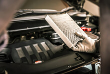 Auto Mechanic Checking, Cleaning And Replacing Car Air Filter. Concept Of Car Care Service Maintenance.