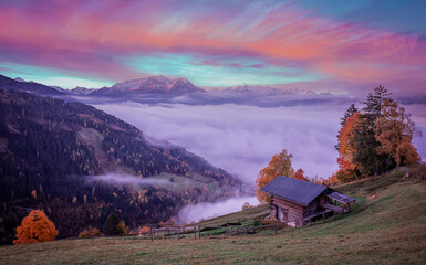 Fotobehang - Fabulous Autumn landscape on pink sunset. alpine farmland, pasture and high rocky mountains in background, Foggy summer morning in the mountains valley. Creative image. Zell am See. Austria.