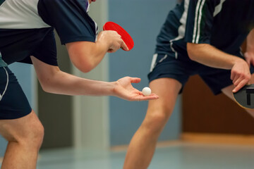 Table Tennis Player serving, holding ball in hand	