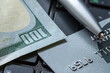 © Павел Мещеряков - american dollars with credit card and pen lying on laptop keyboard