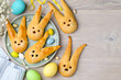 Easter bunny buns from yeast dough on plate. Traditional Easter dessert rabbits, symbol, concept, decoration. Top view. Copy space
