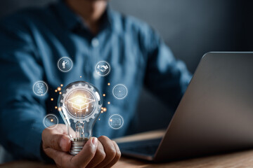 Fototapete - E-learning online education course degree certificate, Man using computer holding lightbulb with learning educate and graduation study knowledge to creative thinking idea and problem solving solution