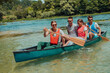 © .shock - Group adventurous explorer friends are canoeing in a wild river