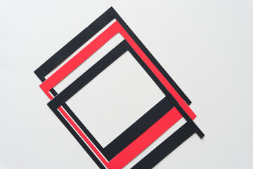 Sticker - three overlapping black and red paper frames on blank paper