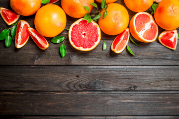 Wall Mural - Ripe grapefruits with leaves.