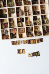 Poster - thinking of you and wooden box with chipboard tiles displaying vintage style letters