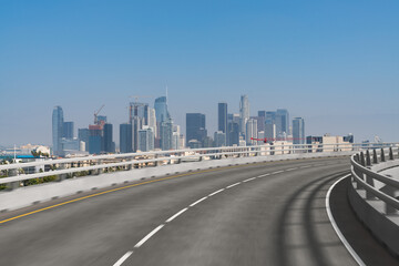 Empty urban asphalt road exterior with city buildings background. New modern highway concrete construction. Concept of way to success. Transportation logistic industry fast delivery. Los Angeles. USA.