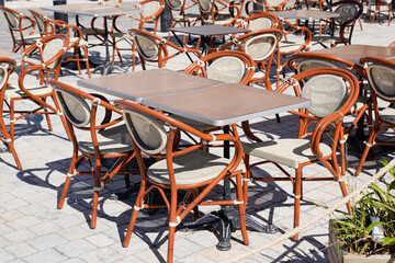 wooden classic french chairs on cafe outdoor restaurant coffee and metal tables parisian terrace