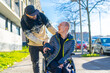 © unai - A disabled person in a wheelchair with a friend smiling, handicapped normality