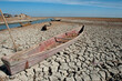 © John Wreford  - A traditional Marsh Arab canoe known as a Mashoof abandoned on the dry cracked earth of the southern marshes of Iraq during a hash summer drought.