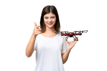 Wall Mural - Young Russian woman holding a drone over isolated chroma key background points finger at you with a confident expression