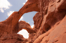 People Exploring Two Arches.  Arches National Park, Moab, Utah.
