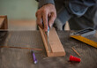 © Ali - carpenter measuring wood