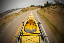Driving Along Horsetooth Reservoir With A Kayak On Top Of The Car Near Fort Collins, Colorado.