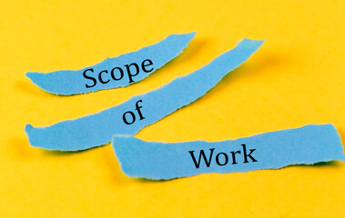 Poster - SCOPE OF WORK text on a blue pieces of paper on yellow background, business concept