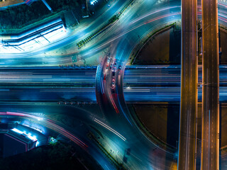 Canvas Print - Aerial view of car traffic transportation above circle road of Drone aerial view fly , high angle. Public transport or commuter city life concept of economic and energy, infrastructure	