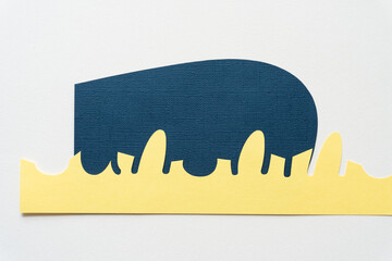 yellow paper with decorative border on blue paper shape