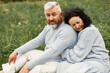 © prostooleh - Senior couple sitting on a grass in a park and hugging