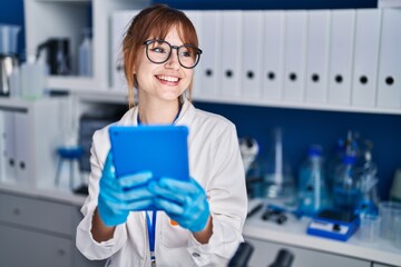 Poster - Young woman scientist smiling confident using touchpad at laboratory