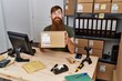 © Krakenimages.com - Redhead man with long beard working at small business ecommerce smiling looking to the side and staring away thinking.