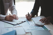 © kamiphotos - Atmosphere of a startup company meeting, business people are meeting together to summarize and plan investment finances, they are the founders of the company. Business administration concept.