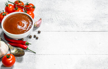 Poster - Tomato sauce in bowl with spoon, garlic and cherry.