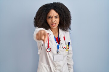 Wall Mural - Young african american woman wearing doctor uniform and stethoscope pointing displeased and frustrated to the camera, angry and furious with you