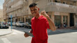 © Krakenimages.com - Young latin man smiling confident using touchpad at street