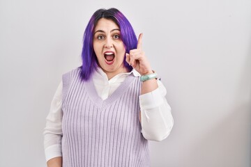 Sticker - Plus size woman wit purple hair standing over white background pointing finger up with successful idea. exited and happy. number one.