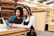 © Vergani Fotografia - black business woman listening to explanation of female colleague at storehouse