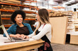 © Vergani Fotografia - happy female worker working with female colleague at warehouse
