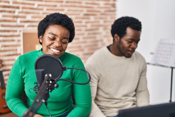 Poster - African american man and woman music group singing song playing keyboard piano at music studio