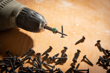 Poster - Drill with screws on the table.