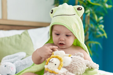 Sticker - Adorable caucasian baby wearing funny towel playing with toys at bedroom