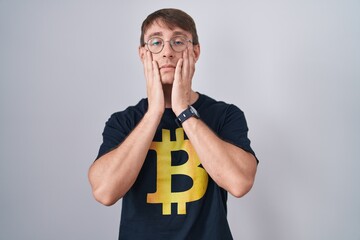 Sticker - Caucasian blond man wearing bitcoin t shirt tired hands covering face, depression and sadness, upset and irritated for problem