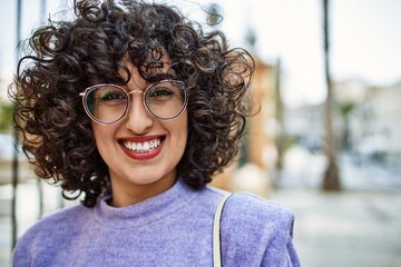 Sticker - Young middle east woman smiling confident wearing glasses at street