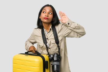 Poster - Young photographer Indian woman holding a suitcase cut out isolated dreaming of achieving goals and purposes