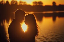  A Couple Is Standing Close To Each Other In Front Of A Lake At Sunset With The Sun Setting Behind Them And The Silhouette Of The Couple's Face And The Water Behind Them,. Generative Ai