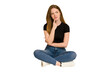 © Asier - Young redhead woman sitting on the floor cut out isolated looking sideways with doubtful and skeptical expression.