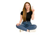 © Asier - Young redhead woman sitting on the floor cut out isolated showing number one with finger.