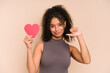 Young african american woman holding a heart for valentines day isolated feels proud and self confident, example to follow.